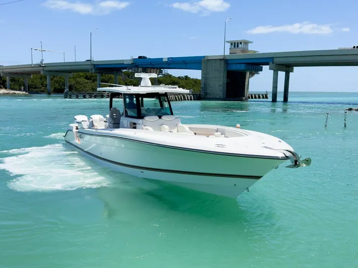 Aquamarine Yacht Photos Pics 2019 HCB 39 Speciale boat cruising in turquoise waters near a bridge.