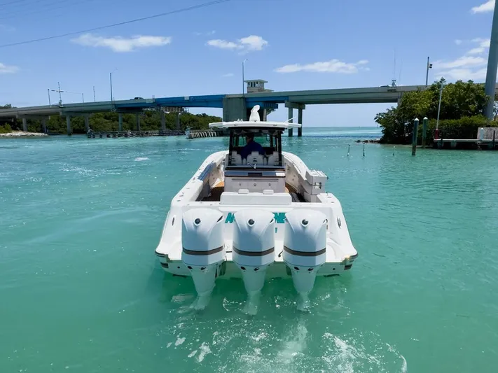 Aquamarine Yacht Photos Pics 2019 HCB 39 Speciale boat cruising in turquoise waters near a bridge.