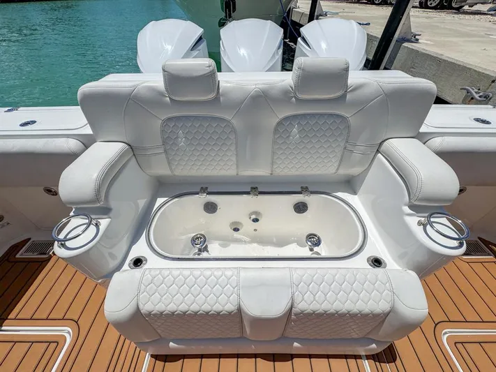 Aquamarine Yacht Photos Pics Luxurious seating on 2019 HCB 39 Speciale boat with white upholstery and cup holders.