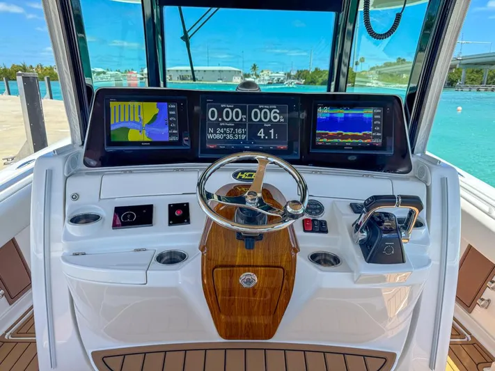 Aquamarine Yacht Photos Pics 2019 HCB 39 Speciale boat dashboard with navigation screens and steering wheel.