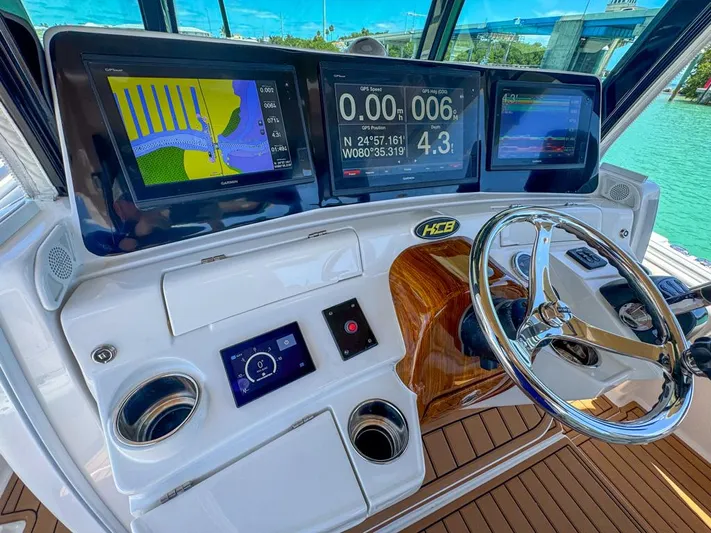 Aquamarine Yacht Photos Pics 2019 HCB 39 Speciale boat dashboard with navigation screens and steering wheel.