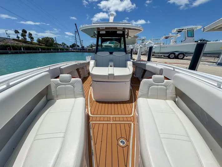 Aquamarine Yacht Photos Pics 2019 HCB 39 Speciale boat with luxurious seating and teak flooring, docked by the water.