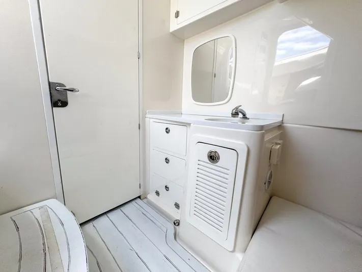 Aquamarine Yacht Photos Pics 2019 HCB 39 Speciale boat interior with sink, mirror, and storage cabinets.