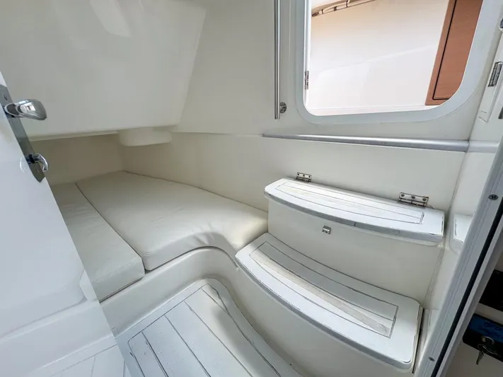 Aquamarine Yacht Photos Pics 2019 HCB 39 Speciale cabin interior with white seating and window.