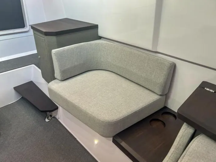  Yacht Photos Pics 2024 Axopar 37XC CROSS CABIN interior with gray seating and dark wood accents.