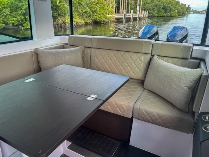  Yacht Photos Pics Luxurious interior of 2024 Axopar 37XC CROSS CABIN with plush seating and table.