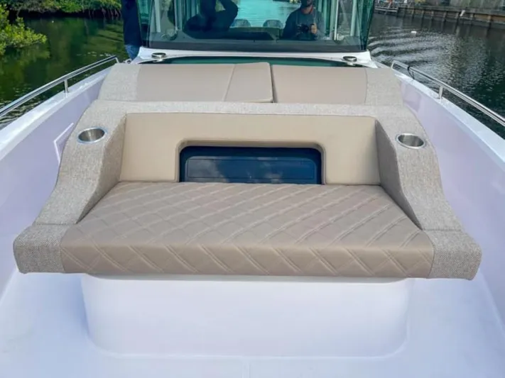  Yacht Photos Pics 2024 Axopar 37XC CROSS CABIN boat with cushioned seating and cup holders on deck.