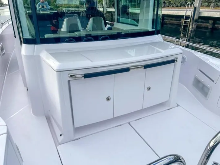 Yacht Photos Pics 2024 Axopar 37XC CROSS CABIN boat interior with sleek white cabinetry.