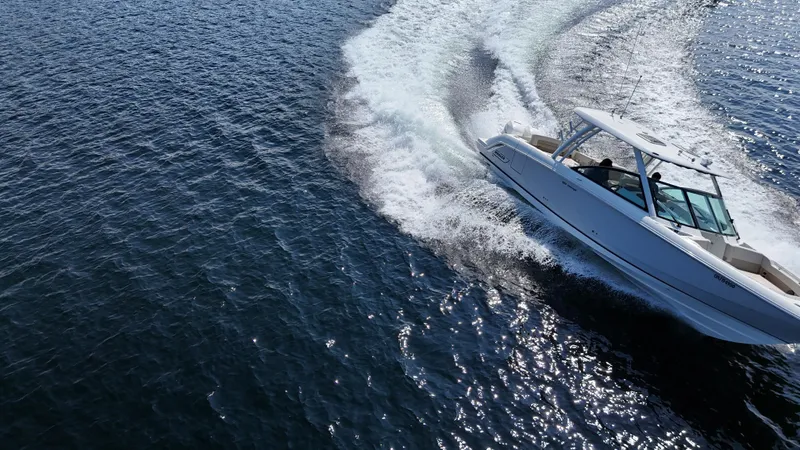  Yacht Photos Pics 2019 Boston Whaler 320 Vantage cruising swiftly on open water.