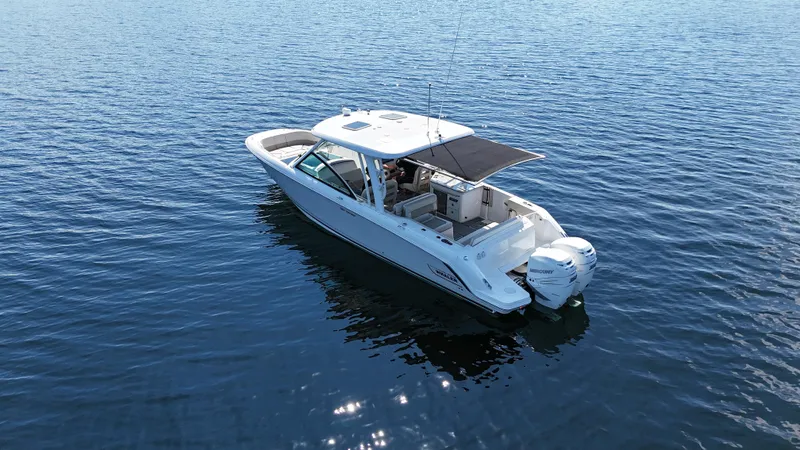  Yacht Photos Pics 2019 Boston Whaler 320 Vantage boat on calm blue water.