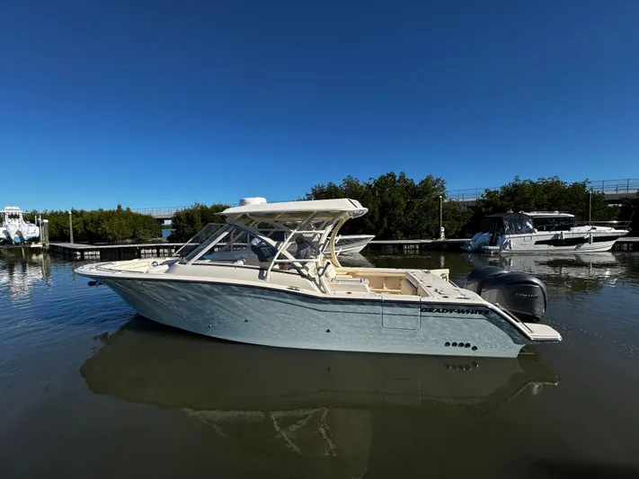 None Yacht Photos Pics 2022 Grady-White Freedom 325 boat on calm water under clear blue sky.