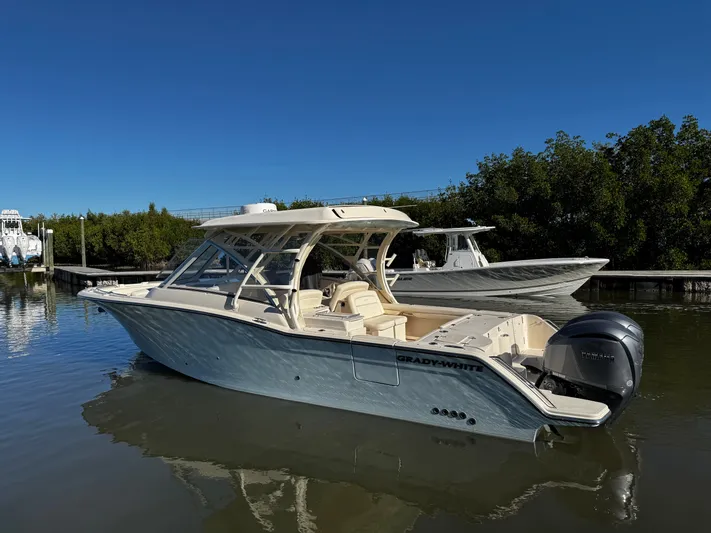 None Yacht Photos Pics 2022 Grady-White Freedom 325 boat docked on calm water under clear blue sky.