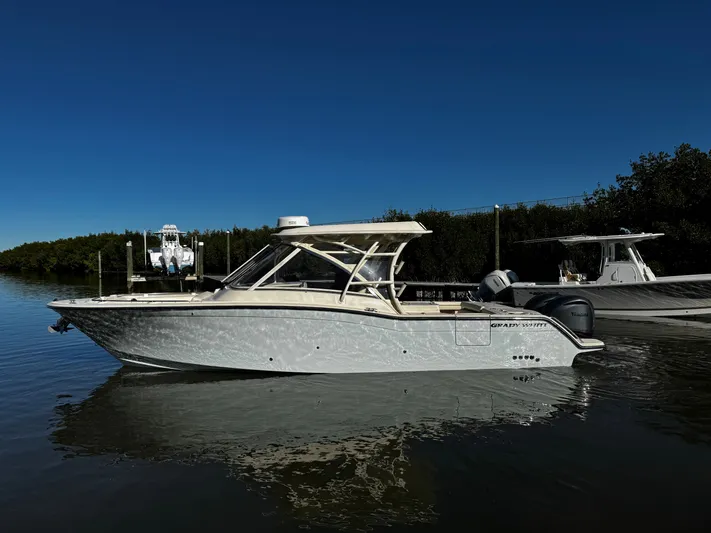 None Yacht Photos Pics 2022 Grady-White Freedom 325 boat on calm water under clear blue sky.