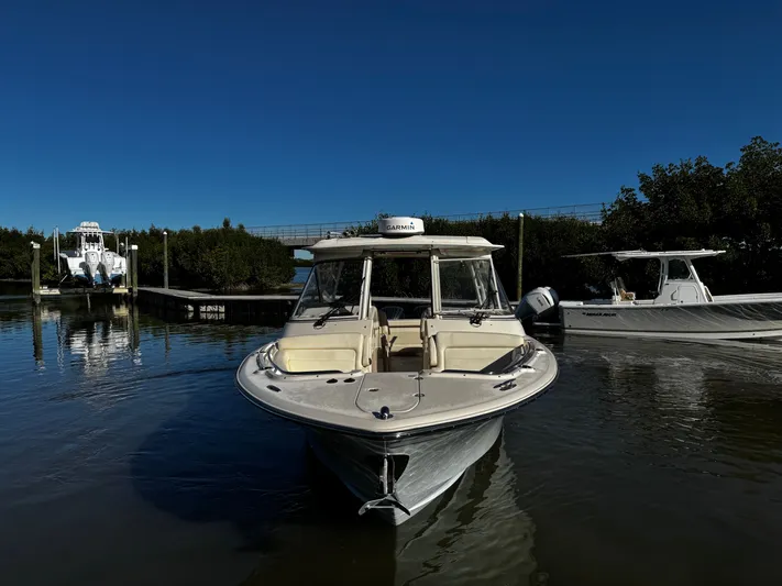 None Yacht Photos Pics 2022 Grady-White Freedom 325 boat docked in calm waters under clear blue sky.