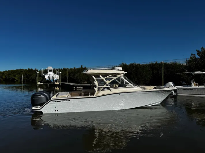 None Yacht Photos Pics 2022 Grady-White Freedom 325 boat on calm water under clear blue sky.