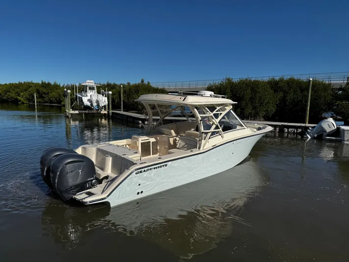 None Yacht Photos Pics 2022 Grady-White Freedom 325 boat docked in calm waters under clear blue sky.