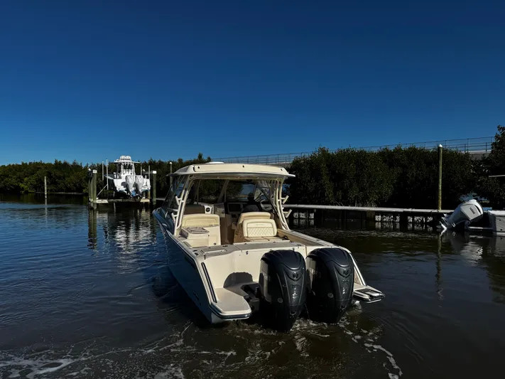 None Yacht Photos Pics 2022 Grady-White Freedom 325 boat on calm water, featuring dual outboard engines.