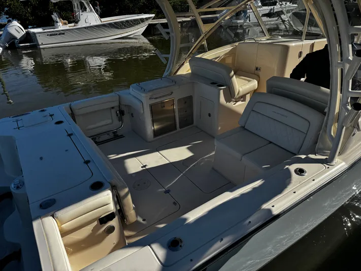 None Yacht Photos Pics 2022 Grady-White Freedom 325 boat interior with seating and storage, docked on calm water.