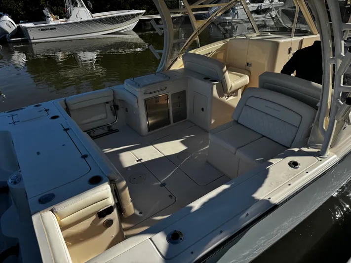 None Yacht Photos Pics 2022 Grady-White Freedom 325 boat interior with seating and storage, docked on calm water.