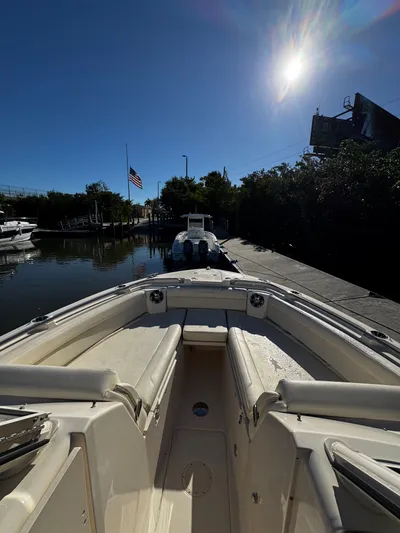 None Yacht Photos Pics 2022 Grady-White Freedom 325 boat docked under bright sun, American flag visible.