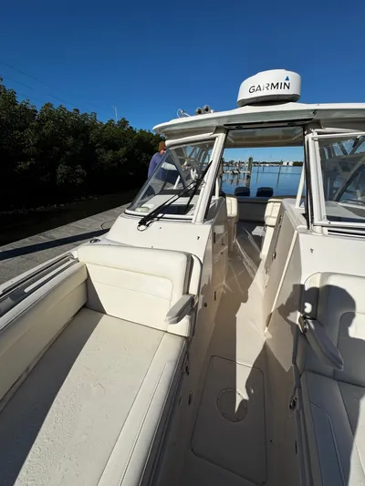 None Yacht Photos Pics 2022 Grady-White Freedom 325 boat with Garmin equipment, docked under clear blue sky.