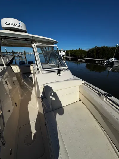 None Yacht Photos Pics 2022 Grady-White Freedom 325 boat docked, featuring Garmin equipment under clear blue skies.