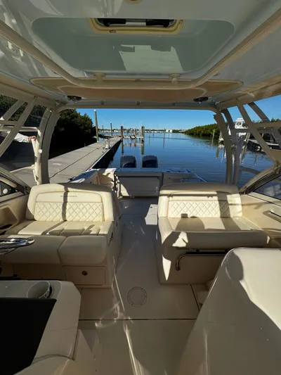 None Yacht Photos Pics 2022 Grady-White Freedom 325 boat interior with luxurious seating and waterfront view.