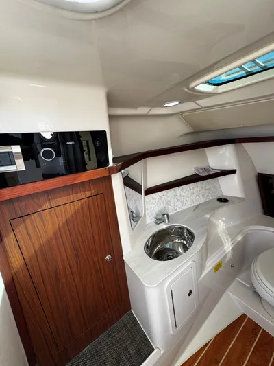 None Yacht Photos Pics 2022 Grady-White Freedom 325 interior with sink, wooden cabinetry, and modern design.
