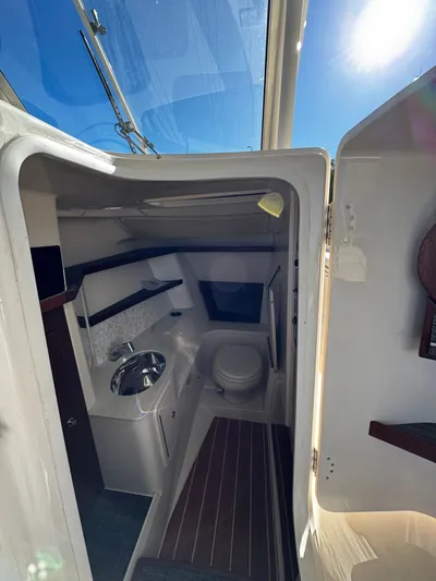 None Yacht Photos Pics 2022 Grady-White Freedom 325 boat interior with compact bathroom and sink.