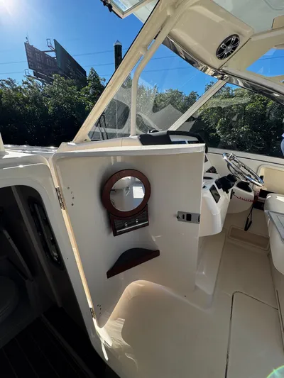 None Yacht Photos Pics 2022 Grady-White Freedom 325 boat interior with open door and steering wheel.