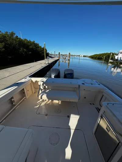None Yacht Photos Pics 2022 Grady-White Freedom 325 boat docked by a serene waterfront.