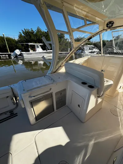 None Yacht Photos Pics 2022 Grady-White Freedom 325 boat interior with seating and storage, docked by the water.