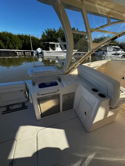 None Yacht Photos Pics 2022 Grady-White Freedom 325 boat interior with seating and storage, docked by the water.