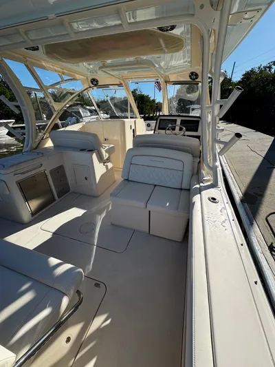 None Yacht Photos Pics 2022 Grady-White Freedom 325 boat interior with seating and helm, docked under clear skies.
