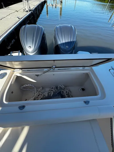 None Yacht Photos Pics 2022 Grady-White Freedom 325 boat with open storage compartment and twin engines at dock.