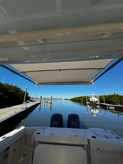 None Yacht Photos Pics 2022 Grady-White Freedom 325 boat docked, featuring dual engines and a sunshade canopy.