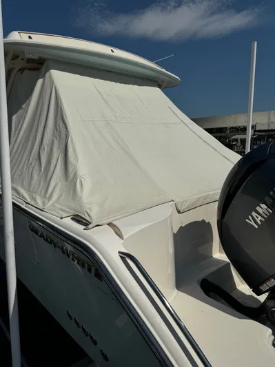 None Yacht Photos Pics 2022 Grady-White Freedom 325 boat with cover and Yamaha engine, docked under clear sky.
