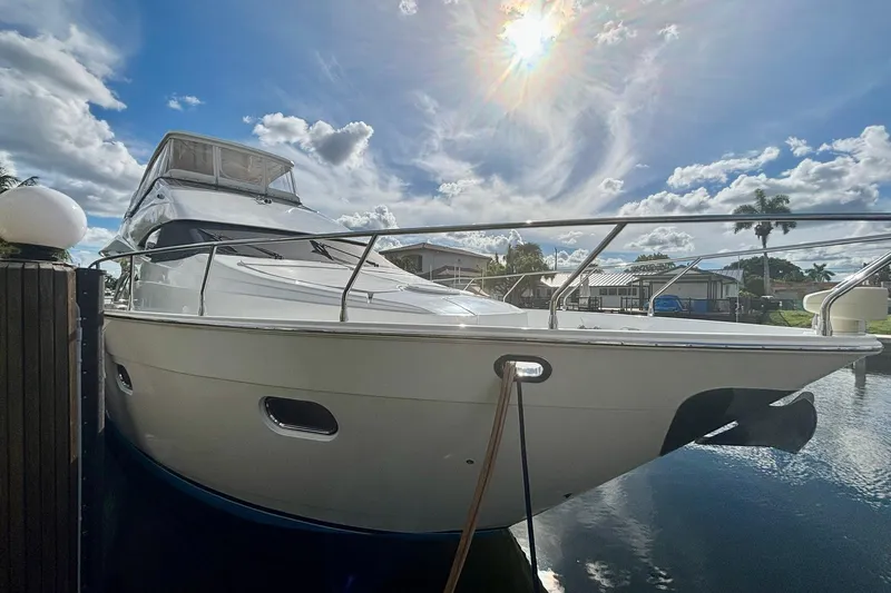  Yacht Photos Pics Luxury 2004 Marquis 59 yacht docked under a bright, sunny sky.