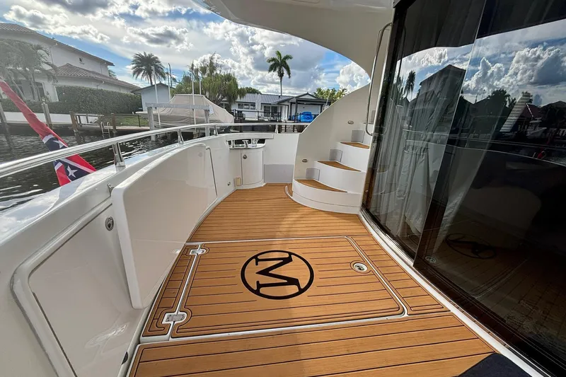  Yacht Photos Pics Luxurious 2004 Marquis 59 yacht deck with wooden flooring and elegant design.