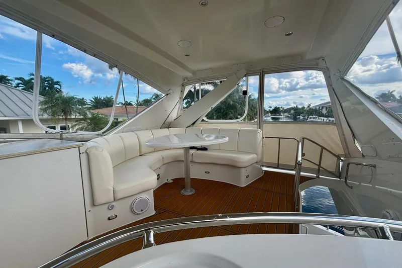  Yacht Photos Pics Luxurious 2004 Marquis 59 yacht interior with white seating and scenic water view.