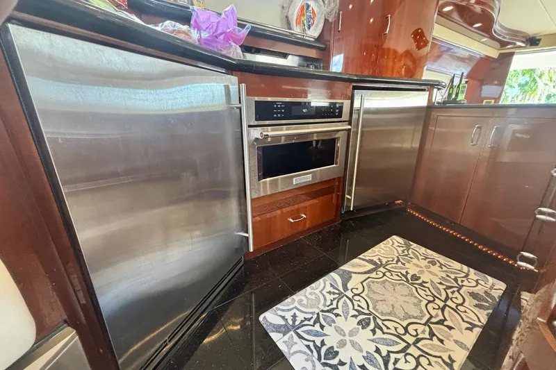  Yacht Photos Pics Luxurious kitchen in 2004 Marquis 59 yacht with stainless steel appliances and elegant cabinetry.