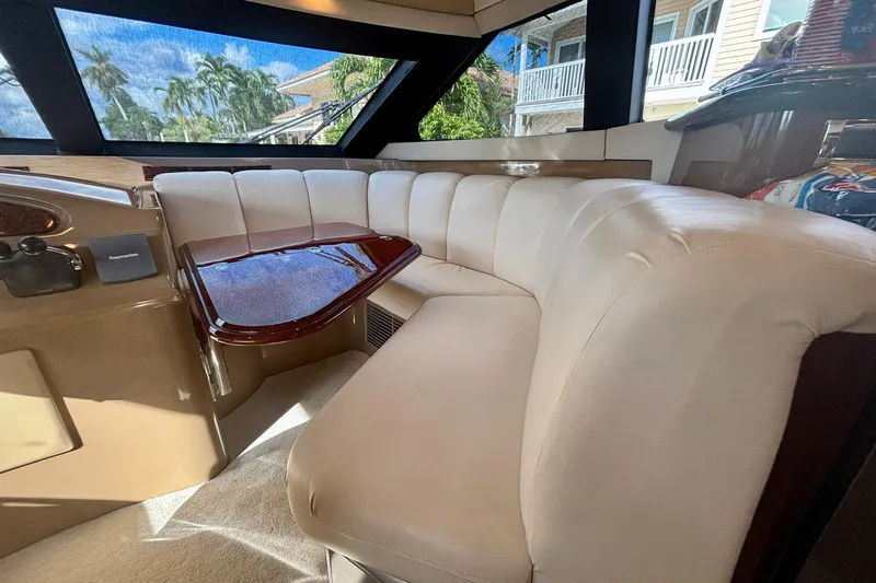  Yacht Photos Pics Luxurious interior of a 2004 Marquis 59 yacht with plush seating and elegant wood table.