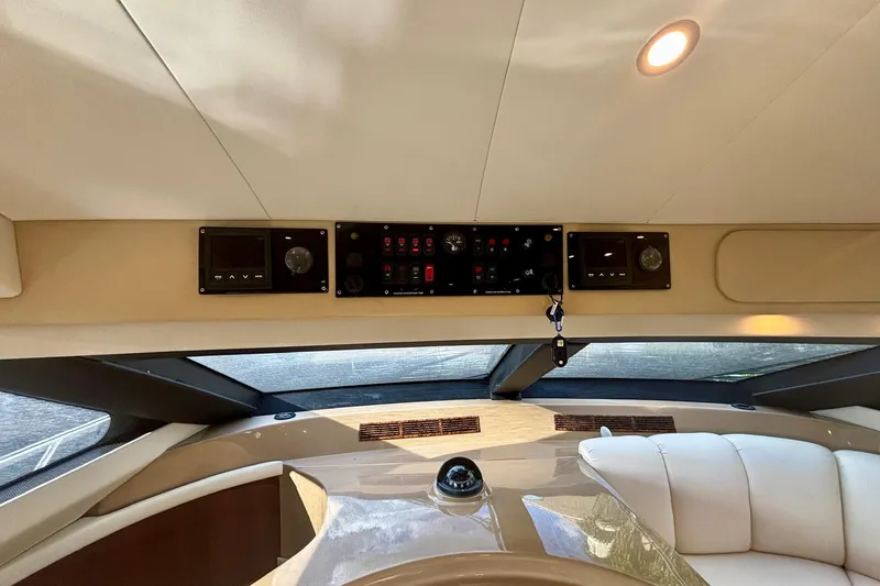  Yacht Photos Pics Interior view of 2004 Marquis 59 yacht dashboard with control panels and seating.