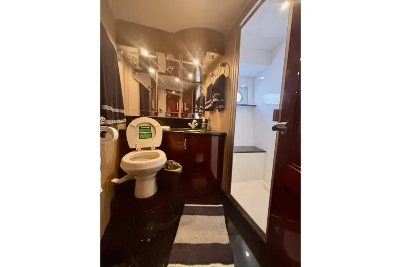 Yacht Photos Pics Luxurious bathroom in 2004 Marquis 59 yacht with modern fixtures and elegant design.