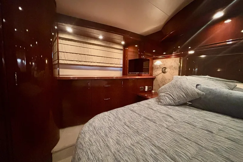  Yacht Photos Pics Luxurious 2004 Marquis 59 yacht bedroom with elegant wood finishes and cozy bedding.