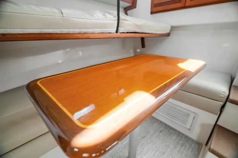 Gyro Stabilized Yacht Photos Pics 2005 Cabo 35 Express interior with polished wooden table and cushioned seating.