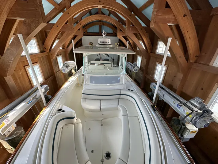 Heron Yacht Photos Pics 2017 Hunt Yachts 32 Center Console in wooden boathouse, showcasing sleek design and spacious interior.