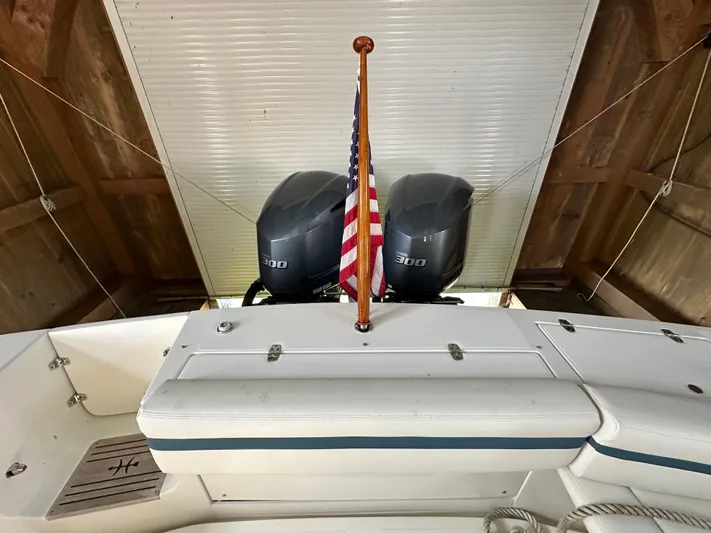 Heron Yacht Photos Pics 2017 Hunt Yachts 32 Center Console with dual 300 engines and American flag in a boathouse.