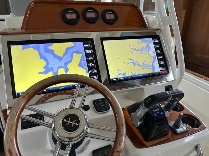 Heron Yacht Photos Pics 2017 Hunt Yachts 32 Center Console helm with dual navigation screens and wooden steering wheel.