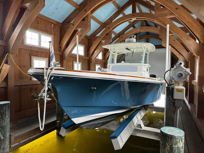 Heron Yacht Photos Pics 2017 Hunt Yachts 32 Center Console in wooden boathouse, elevated on lift.